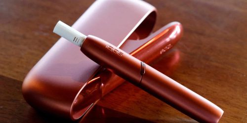 FILE PHOTO: The charger and the holder (top) of the electric tobacco heating system IQOS of cigarette maker Philip Morris Switzerland are displayed after a news conference in Bern, Switzerland November 19, 2019.  REUTERS/Arnd Wiegmann//File Photo